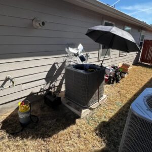 HVAC technician diagnosing AC compressor in Cedar Park TX
