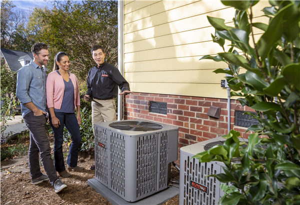 HVAC technician walking a homeowner through their new Trane system and thermostat operation